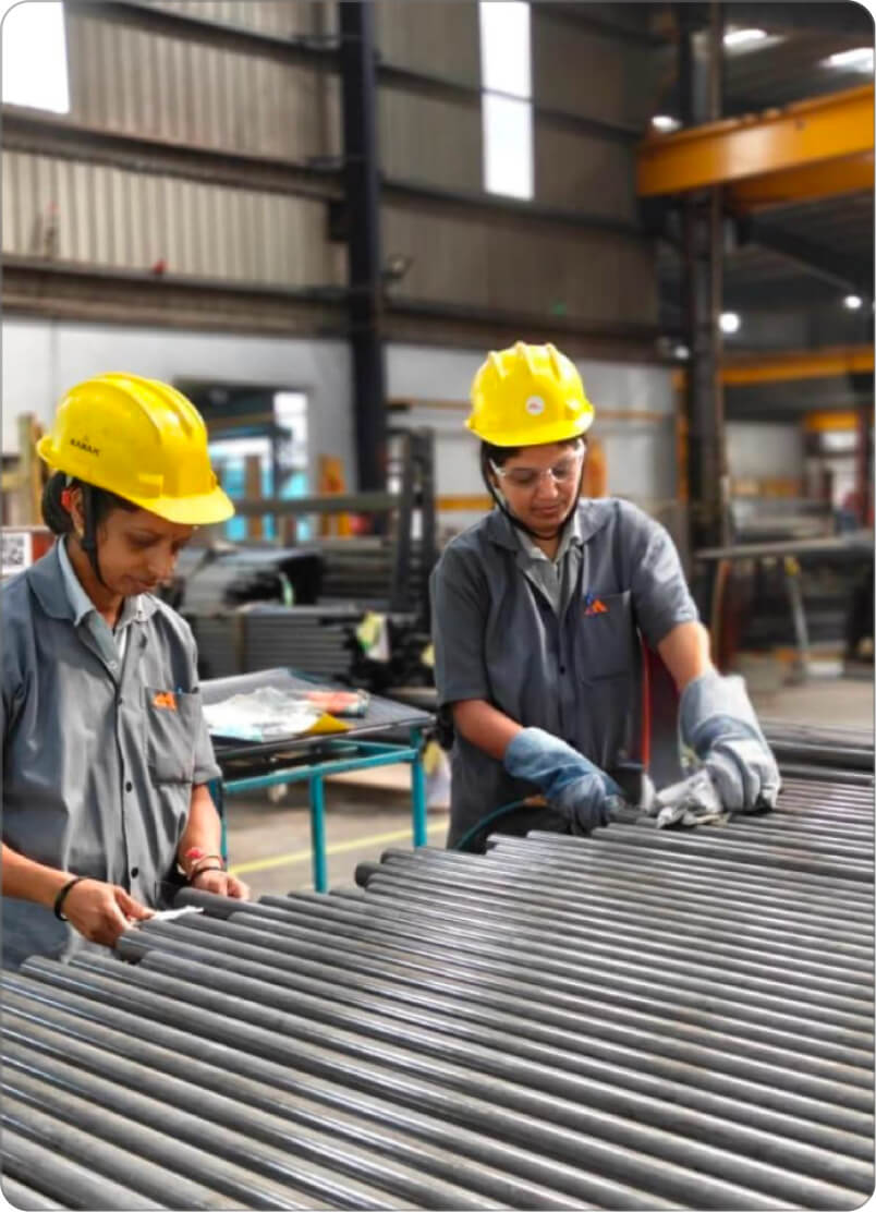 Employees inspecting tubes on the shop floor